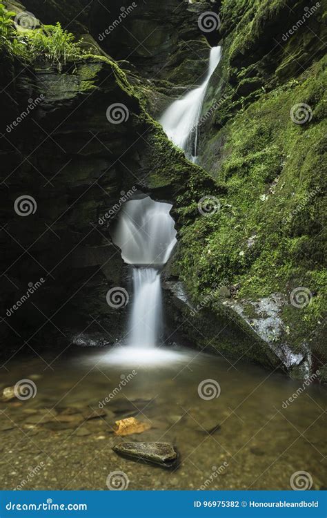 Beautiful Flowing Waterfall With Magical Fairytale Feel In Lush Stock