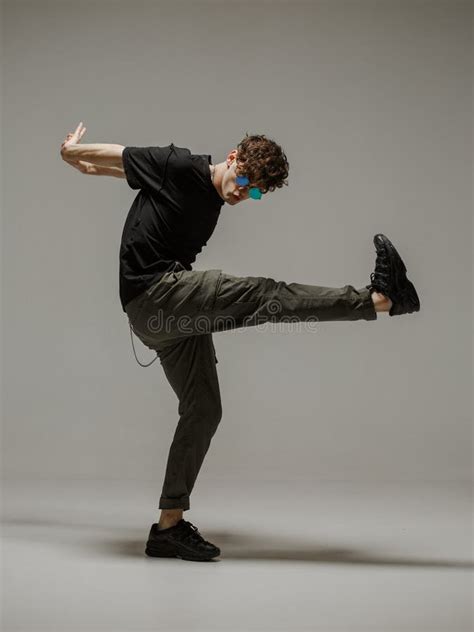 Guy Dancing Contemporary Dance In Studio Neutral Grey Background