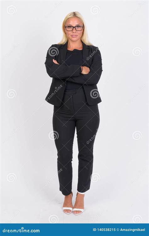 Full Body Shot Of Young Blonde Businesswoman With Arms Crossed Stock