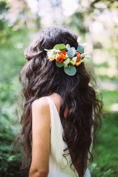 A Woman With Long Hair Wearing A Flower Crown In Her Hair Looking Into