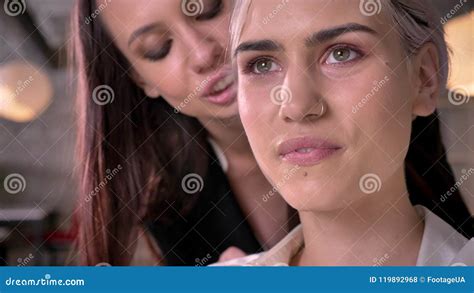 Young Beautiful Lesbian Whispering In One Ear Of Another Woman In