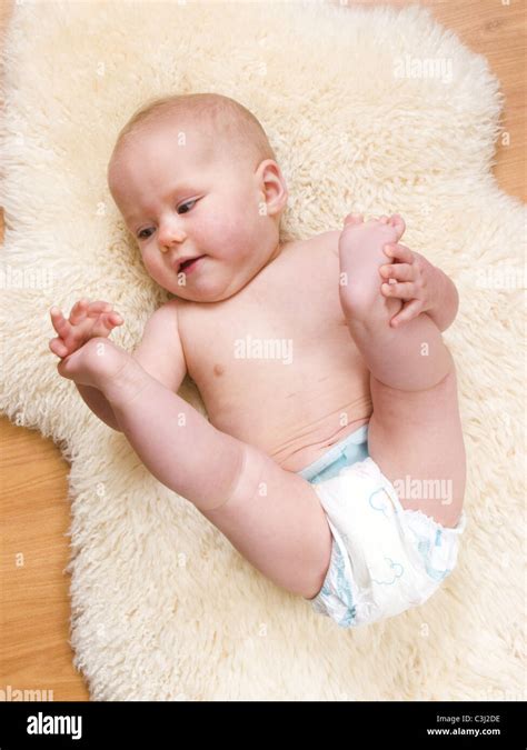 Baby In Nappy Diaper Playing With Feet Stock Photo Alamy