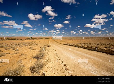 Landscape With Long Dirt Road Stretching Across Vast Plains Of