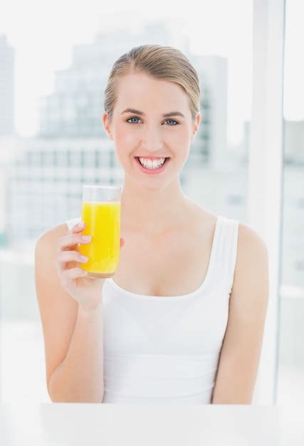 Premium Photo Smiling Blond Woman Holding Orange Juice