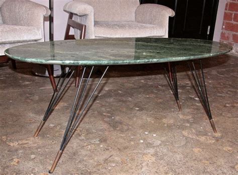 Thick heavy table top with rounded edges rests upon solid marble pedestal base. Italian 50's Green Marble Top Coffee Table at 1stdibs