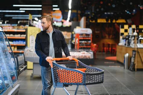 Customer In Supermarket Man Doing Grocery Shopping Standing With Cart