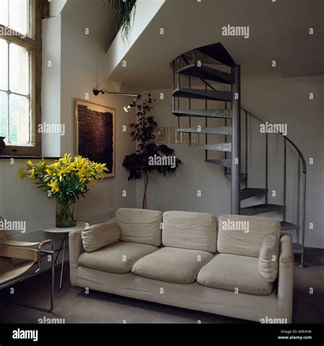 Modern Sofa In Attic Living Room With Spiral Staircase Stock Photo Alamy