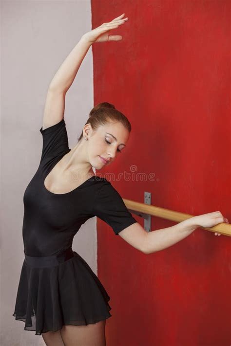 Ballet Dancer Stretching At Barre In Studio Stock Image Image Of