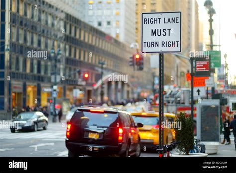 Roadsign In New York Cars Taxi Cabs And People Rushing On Busy