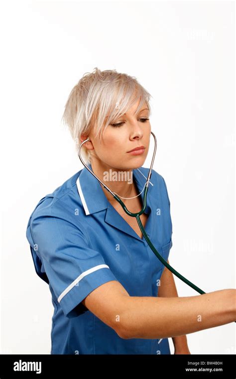 Young Female Doctor Listening Through A Stethoscope Stock Photo Alamy