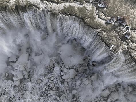 Spectacular Photos Show Niagara Falls Partially Frozen After Winter