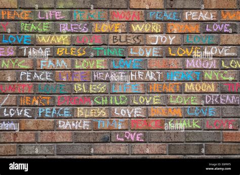 Positive One Word Messages Written In Colored Chalk On A Brick Wall In