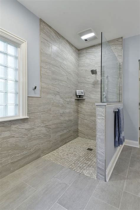 A Bathroom With A Walk In Shower Next To A Window