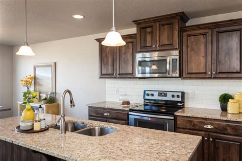 ∙ available for quick ship ∙ traditional and timeless finish. dark cabinets w/ white subway tile | Model homes, Kitchen ...