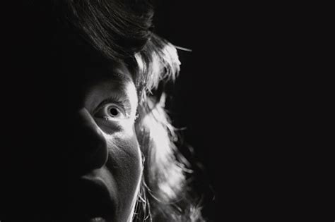 Black And White Portrait Of A Scared Woman Stock Photo Download Image