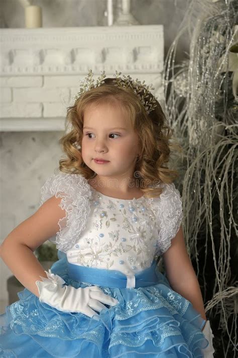 Young Little Princess In Blue With White Elegant Dress And White Gloves