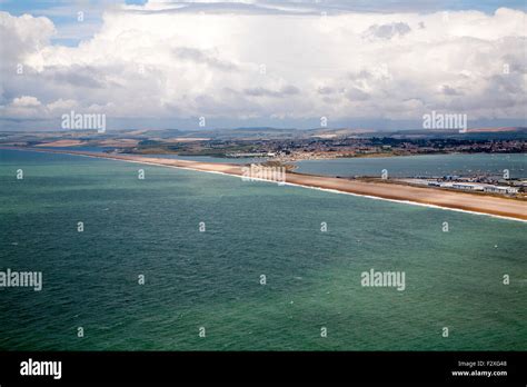Chesil Beach With Weymouth Harbour Beyond Isle Of Portland Dorset