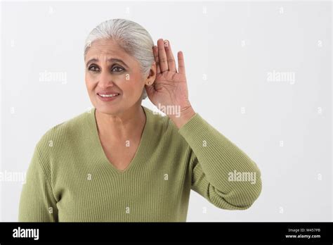Woman Trying To Listen Stock Photo Alamy