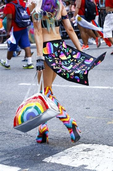 Person Wearing High Heel Boots Carrying Purse In Pride Parade Photo12 Tetra Images Julien