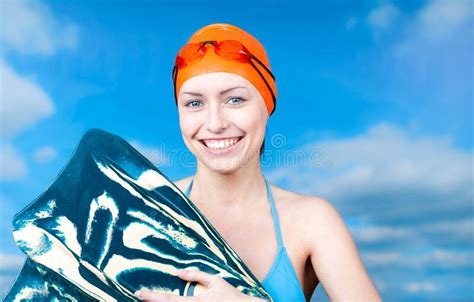 A Winner Young Female Swimmer In An Orange Swimming Cap And Swimming Glasses Stock Image