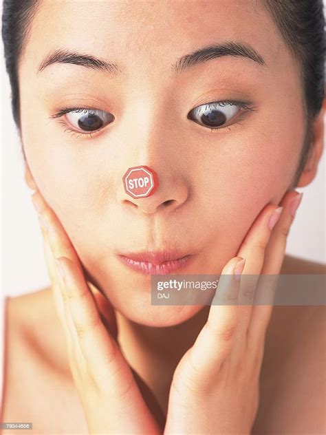 Japanese Woman Looking Down Stop Sign Sticking On Her Nose Photo