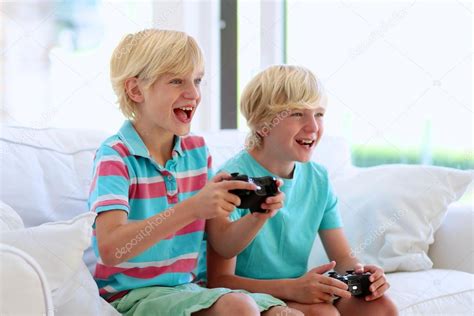 Two Boys Playing Video Games Stock Photo By ©cromary 79597436