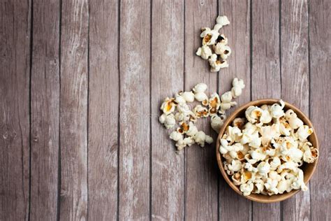 Salt Popcorn On The Wooden Table Popcorn In A Wooden Bowl Stock Photo
