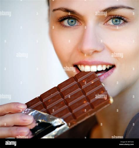 Young Woman Eating Chocolate Stock Photo Alamy