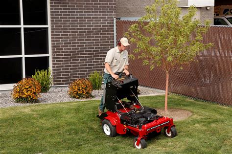 A tractor aerates a golf course, leaving. Expert Spring Lawn Care Tips for Utah Lawns | Stewart's Lawn