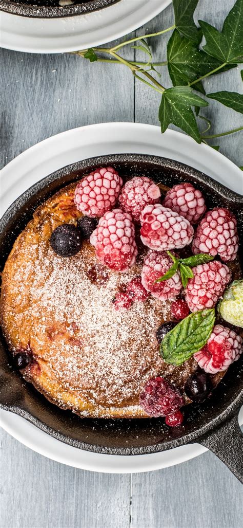 287007 Rustic Cast Iron Skillet Cake With Berries And Powdered Sugar
