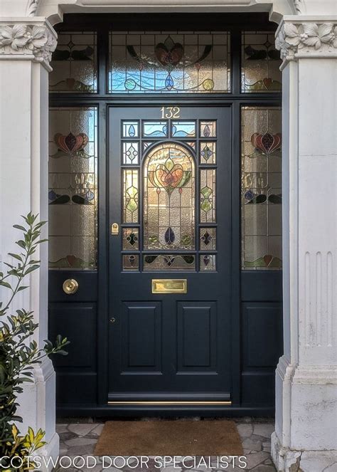 The Front Door Is Decorated With Stained Glass