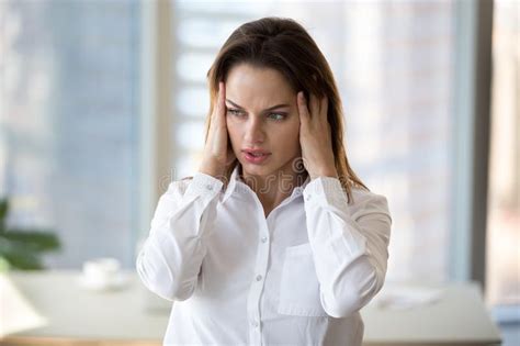 Stressed Tired Businesswoman In Panic Feeling Headache At Work Stock