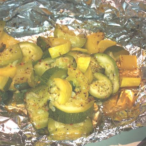 Wrap some veggies, a protein, and a sauce in a piece of foil and then take your pick between throwing the packet onto the grill or into the oven. Squash from our garden grilled in a foil packet. Yum ...