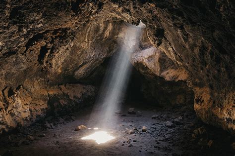 Light Beam Cuts Through The Desert Lava Cave Photograph By Cavan Images