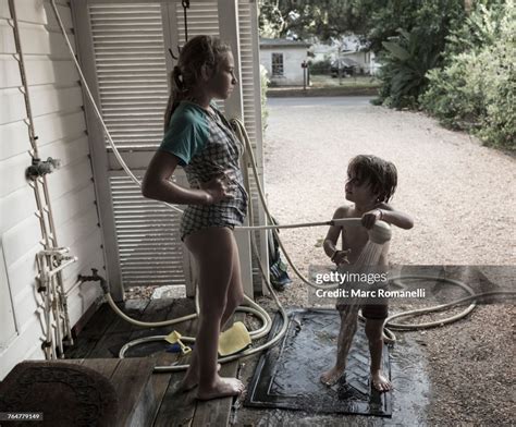 Frustrated Caucasian Girl Watching Brother Using Shower Outdoors High