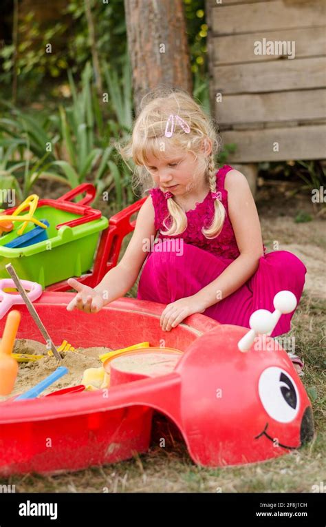 Little Blond Girl Playing In Sandpit On The Playground Stock Photo Alamy