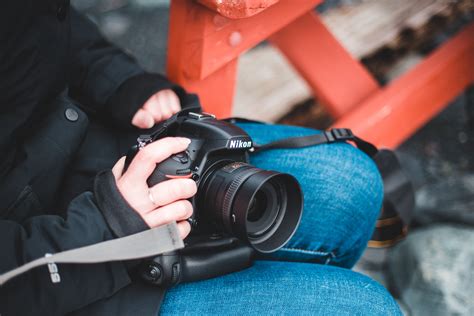 Person Holding Black Nikon Dslr Camera · Free Stock Photo