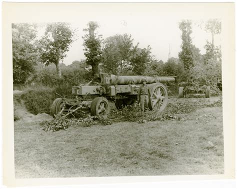 United States Serviceman And German Heavy Artillery Piece In Mortain
