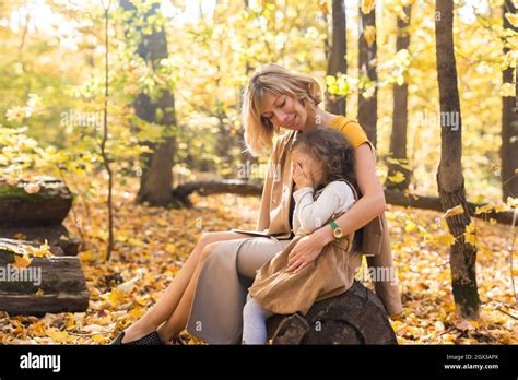 Mother Comforting Her Crying Little Girl In Autumn Nature Emotions And
