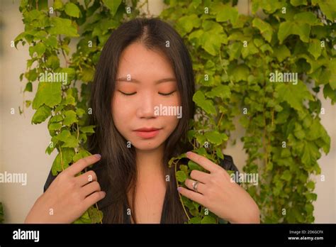 Lifestyle Portrait Of Young Happy And Beautiful Asian Chinese Woman Enjoying Outdoors Posing At