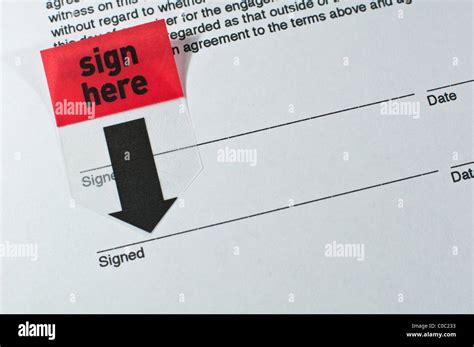 Sign Here Stickers On A Contract Stock Photo Alamy