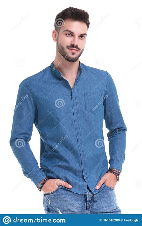 Handsome Casual Man Standing With His Hands In His Pockets Stock Photo