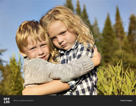 Young Boy And Girl Hugging Stock Photo Offset