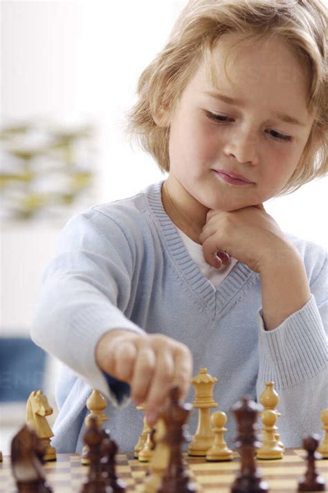 Portrait Of Little Boy Playing Chess Stock Photo