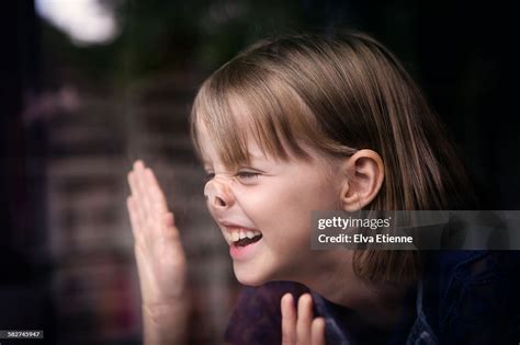 Girl With Nose Pressed Against Glass Window High Res Stock Photo