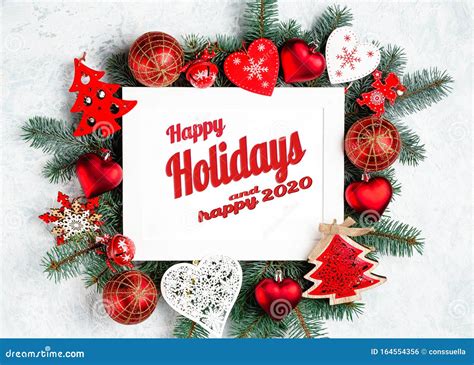 Happy Holidays Lettering In Frame With Christmas Decorations In Red