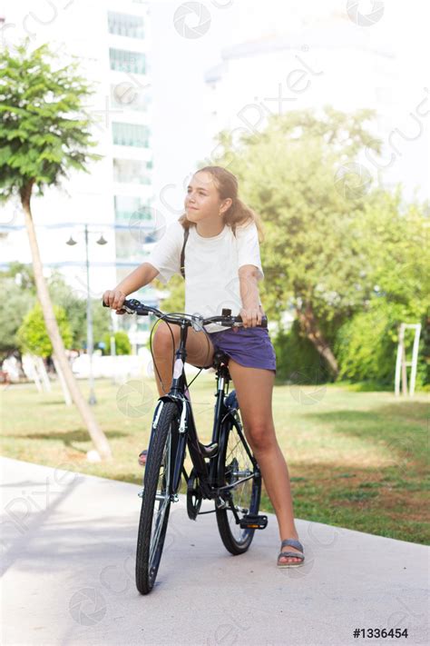 Fashionable Young Teen Girl In Shorts And T Shirt Rides Stock Photo