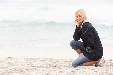 Young Woman On Holiday Kneeling On Beach Stock Image Image Of Smiling