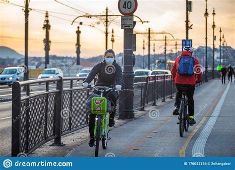 Budapes Hungary 03172020 Cyclist Wearing Face Masks On Margaret Bridge At Sunset During