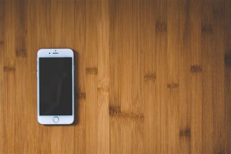 Silver Iphone 6 On Brown Wooden Surface · Free Stock Photo